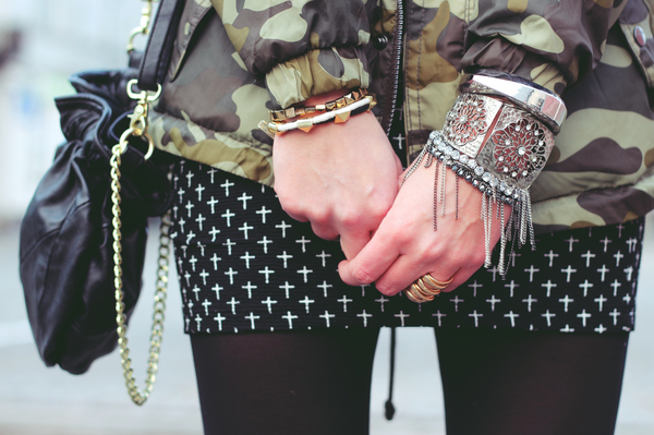 woman in a black and white skirt and camo jacket