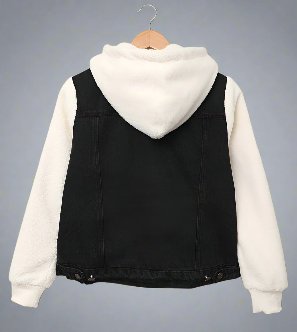 Black and white jacket on a hanger against a beige background