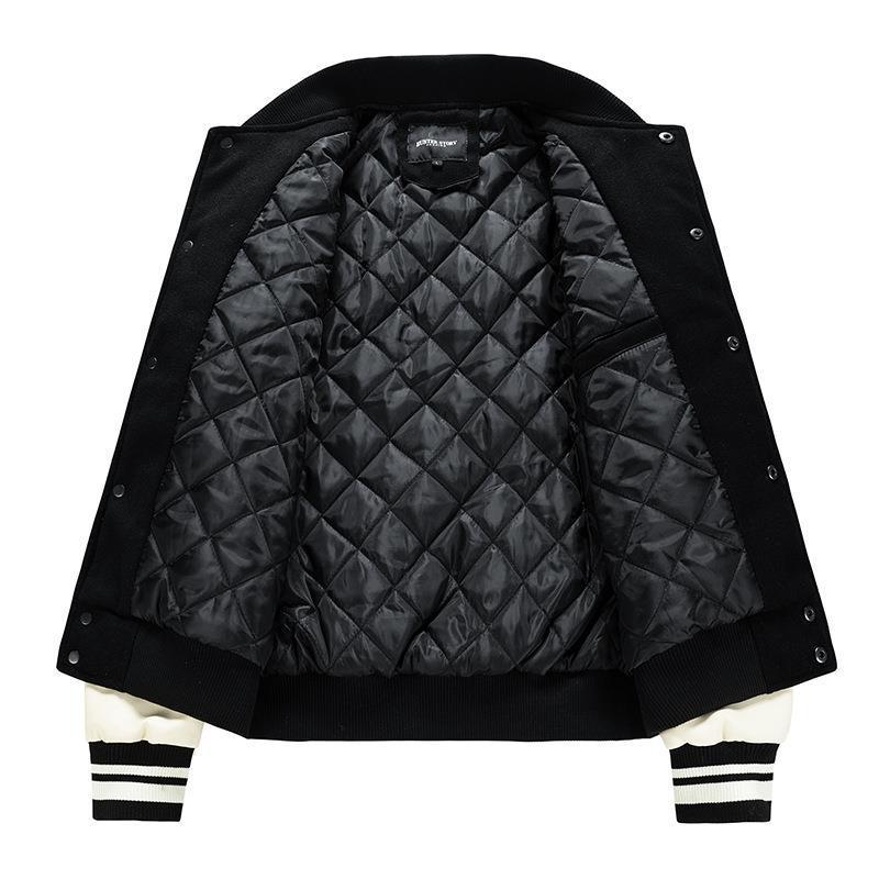 Black quilted jacket with white accents on a white background