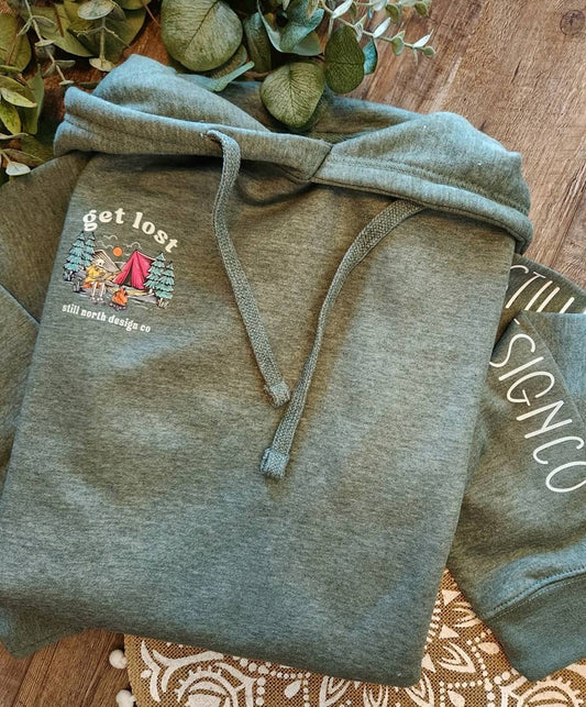 Gray hoodie with a printed design on a wooden surface