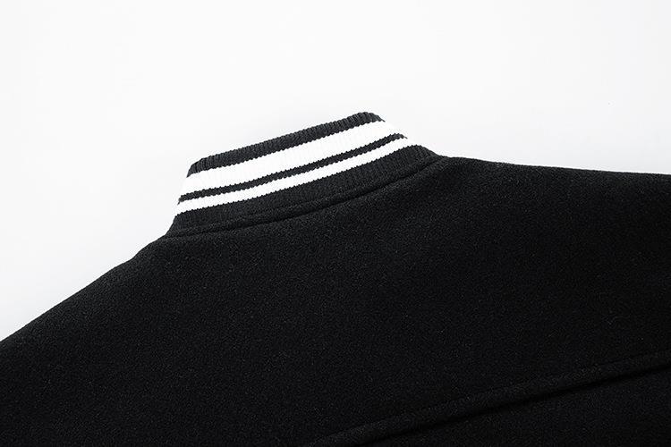 Black sweater with white stripes on the collar against a white background