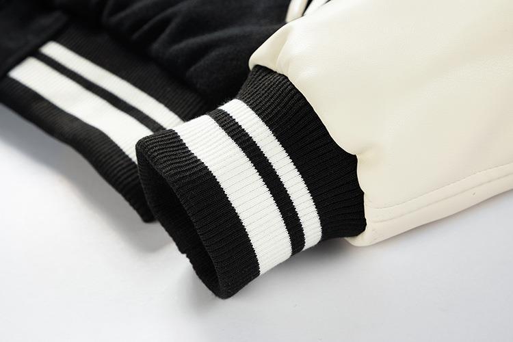 Close-up of black and white striped sleeves on a jacket against a light background