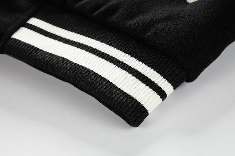 Close-up of a black jacket with white stripes on a light gray background