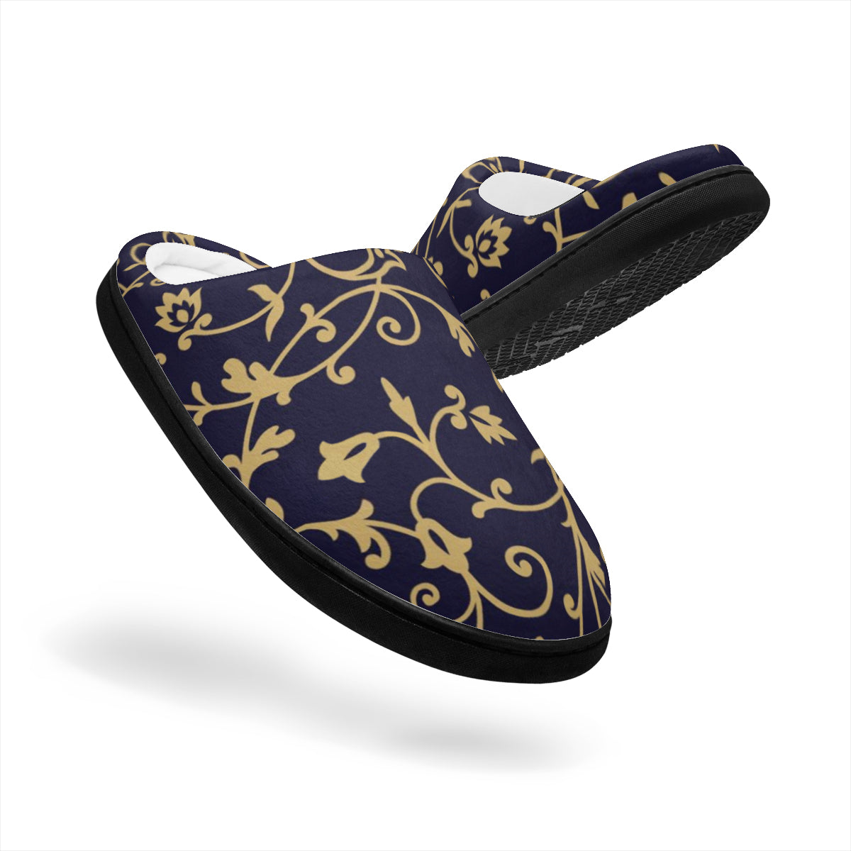 Pair of black slippers with gold floral patterns on a white background
