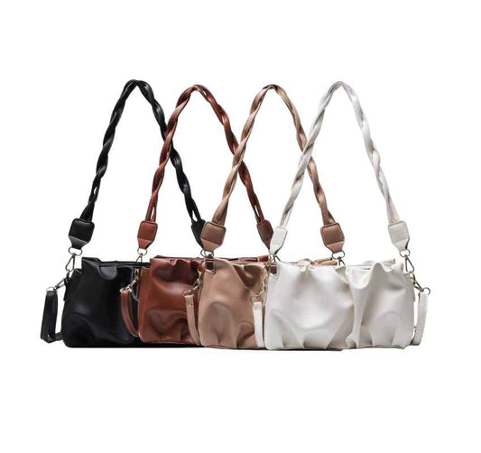 Four purses in neutral colors in a row