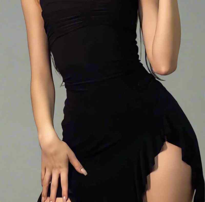 Person wearing a black dress with a gray background