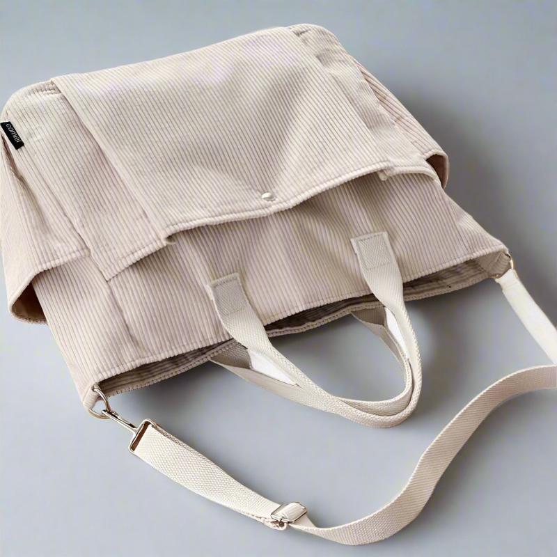 Beige corduroy bag with a strap on a light gray background