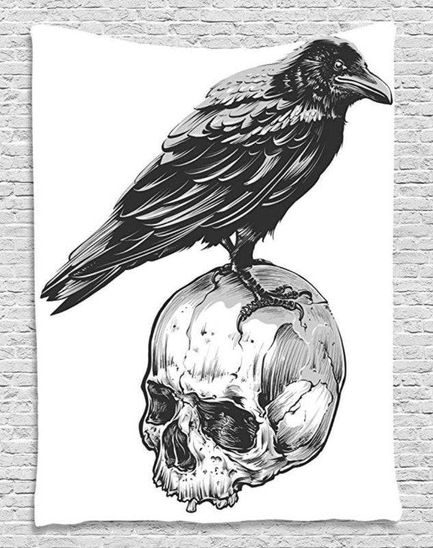 a black & white image of a crow standing on a skull