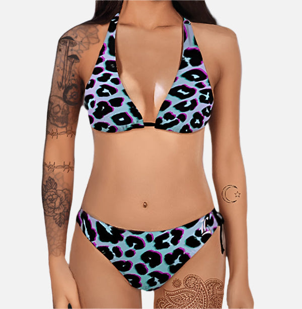A woman in a blue and black leopard print two piece swimsuit