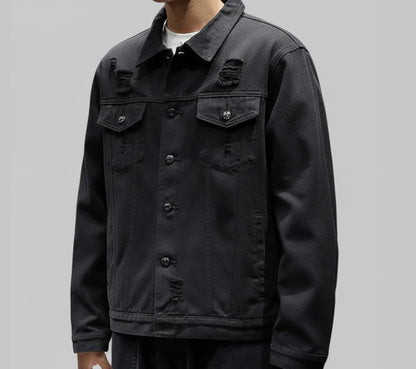 Black distressed jacket worn by a person on a gray background