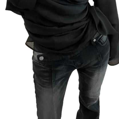 Person wearing a black shirt and dark jeans on a white background