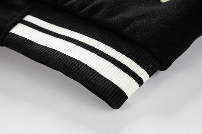 Close-up of a black jacket with white stripes on a light gray background