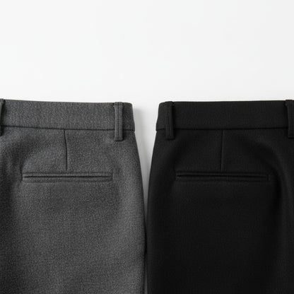 Close-up of gray and black pants on a white background