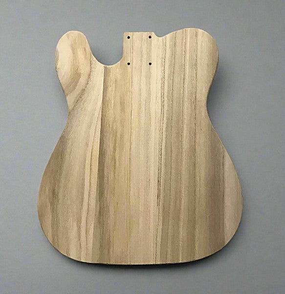 Wooden guitar body on a gray background