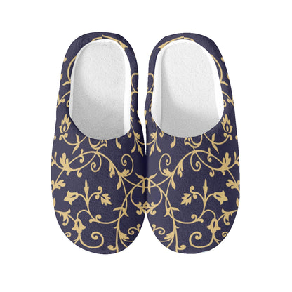 Pair of black slippers with gold floral pattern on a white background