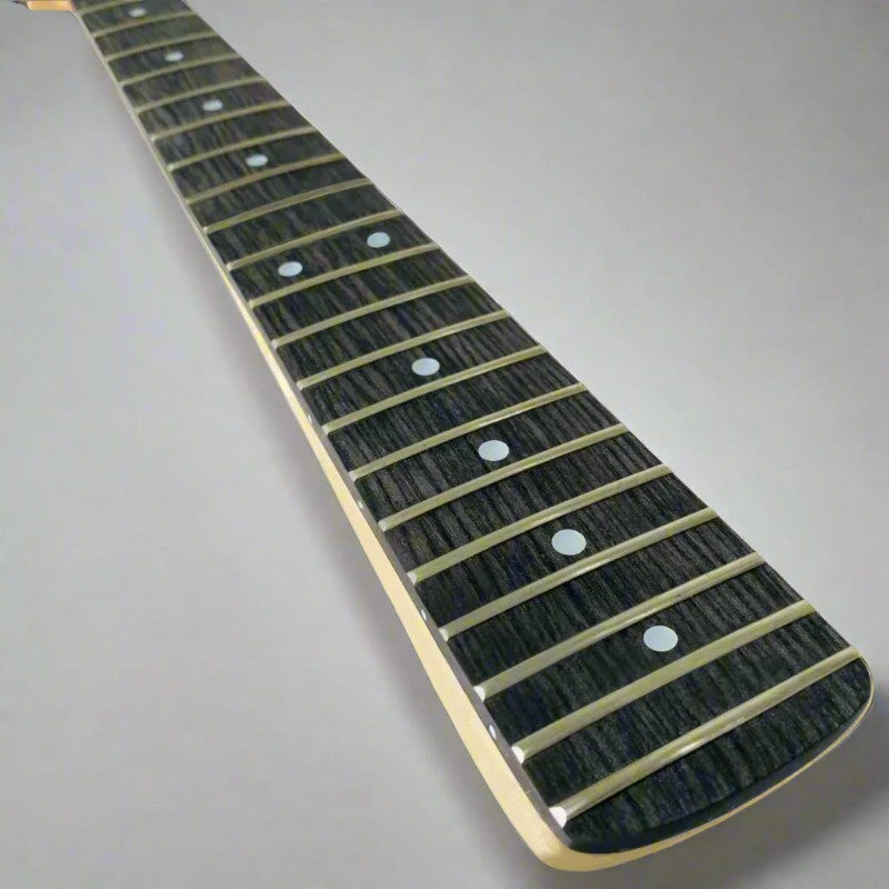 Guitar fretboard with black fingerboard and gold inlays on a gray background