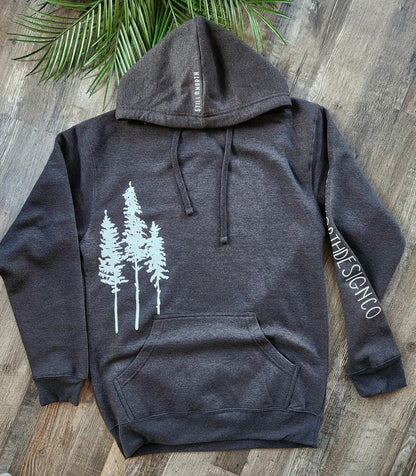 Dark gray hoodie with white tree design on a wooden surface