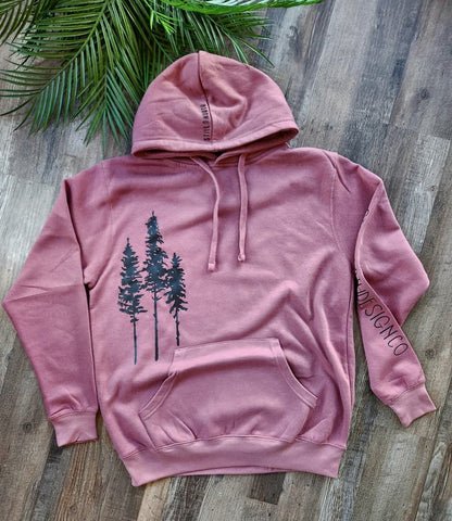 Pink hoodie with tree design on a wooden surface