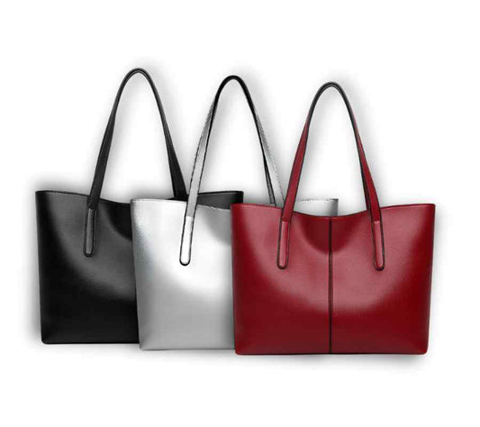 Three handbags in black, silver, and red on a white background