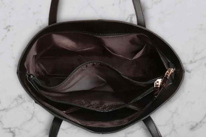 Black handbag with open zipper on a marble surface