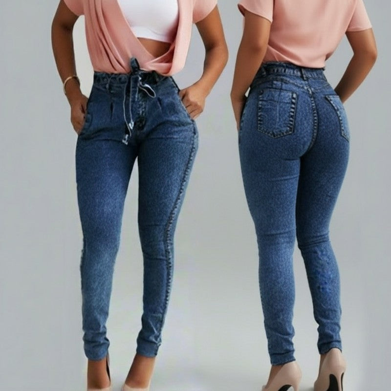 Blue jeans worn by a person on a plain background