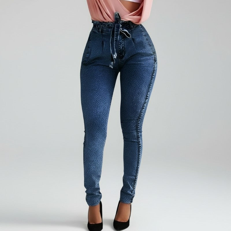 Blue jeans worn by a person on a plain background