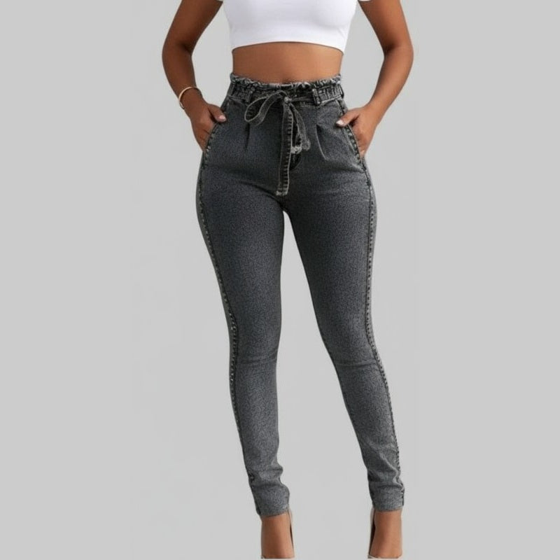 Gray high-waisted jeans worn by a person on a gray background