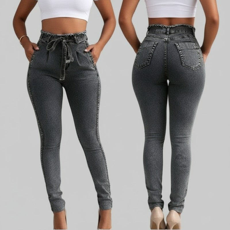2 people showing the front and back of high-waisted dark grey jeans with a paperbag waist and a white crop top stands against a plain gray background 