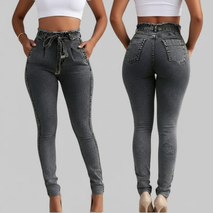 2 people showing the front and back of high-waisted dark grey jeans with a paperbag waist and a white crop top stands against a plain gray background 