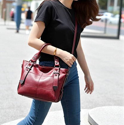 Woman holding a red handbag on a city street
