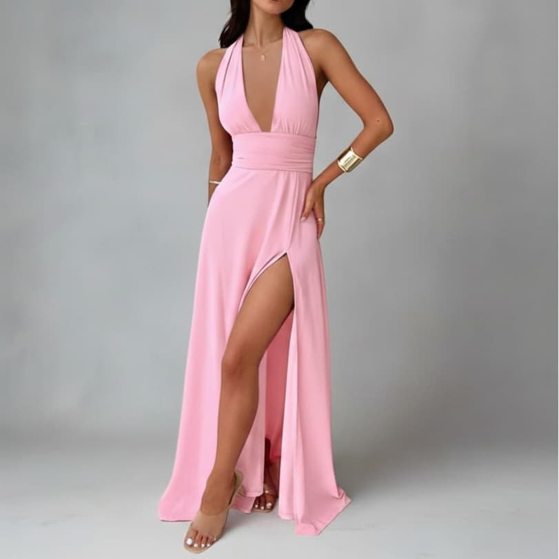Pink halter neck gown with a high slit on a gray background