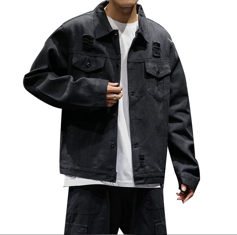 Person wearing a black distressed jacket over a white shirt on a white background