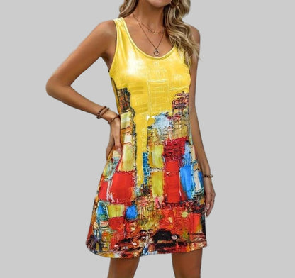 Woman wearing a yellow dress with colorful abstract pattern against a light gray background